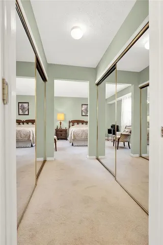 a bathroom with a toilet a sink a tub and mirror