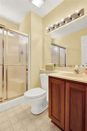 a living room with furniture a flat screen tv and a floor to ceiling window