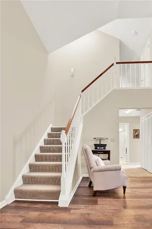 a view of a workspace with furniture and floor to ceiling window