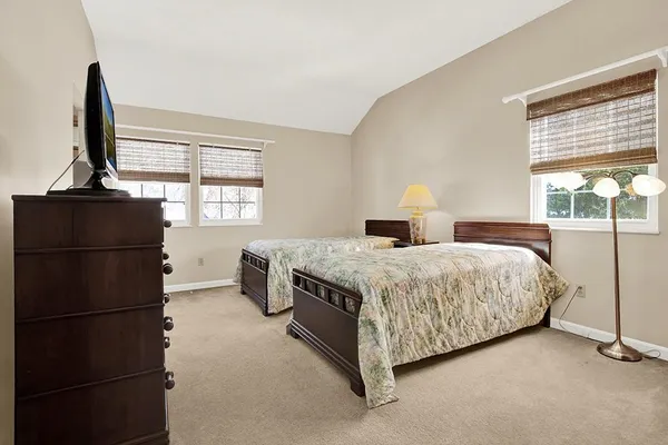 a bedroom with two beds and a table