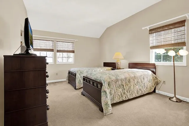 a bedroom with two beds and a table