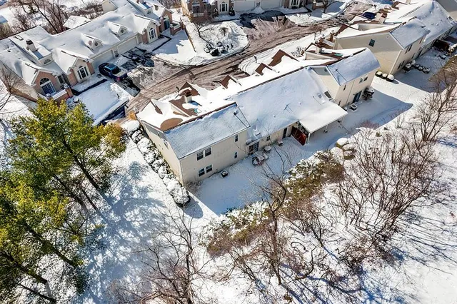 a view of a white house with wooden fence