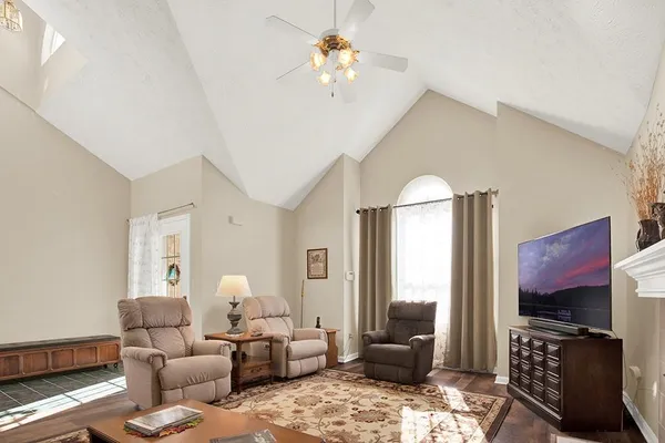 a living room with furniture a window and a fireplace