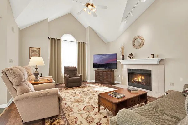 a view of a dining room with furniture a chandelier and wooden floor