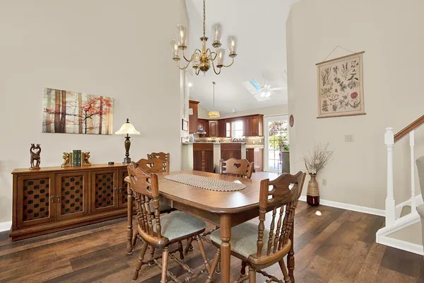 a view of a kitchen with furniture and wooden floor