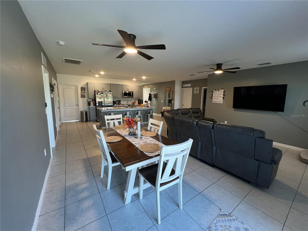 1106 Althea Drive Indian Lake Estates, FL 33843 - Photo 11 of 56 a dining area with furniture and a flat screen tv