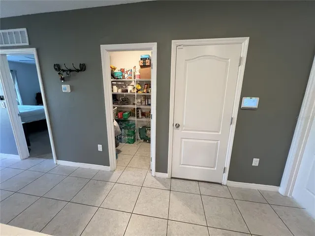 a bedroom with a bed tv and a window