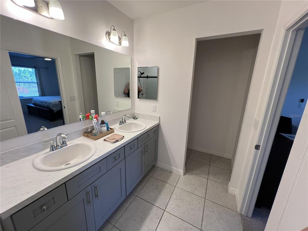1106 Althea Drive Indian Lake Estates, FL 33843 - Photo 15 of 56 a bathroom with a sink vanity and mirror