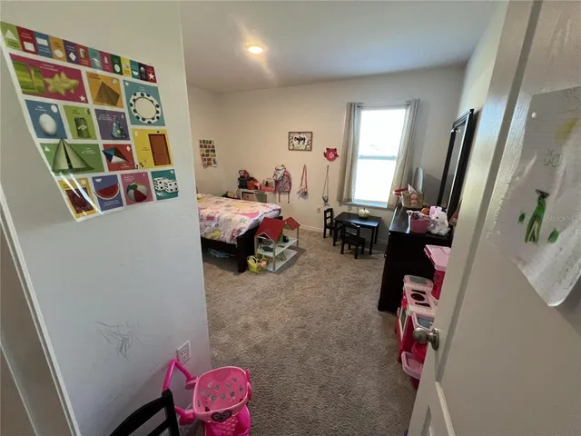 a bedroom with a bed and a mirror