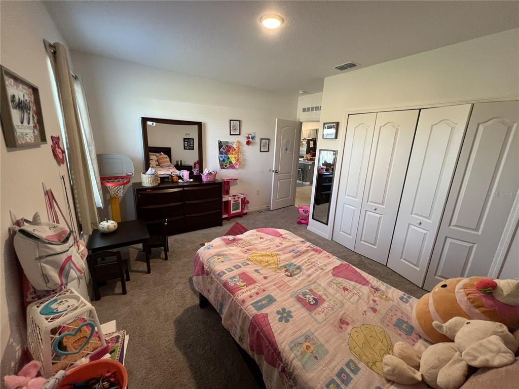 1106 Althea Drive Indian Lake Estates, FL 33843 - Photo 17 of 56 a bedroom with a bed and furniture