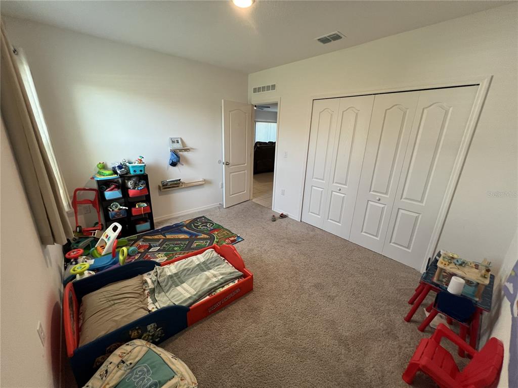 1106 Althea Drive Indian Lake Estates, FL 33843 - Photo 18 of 56 a bedroom with a bed and a mirror