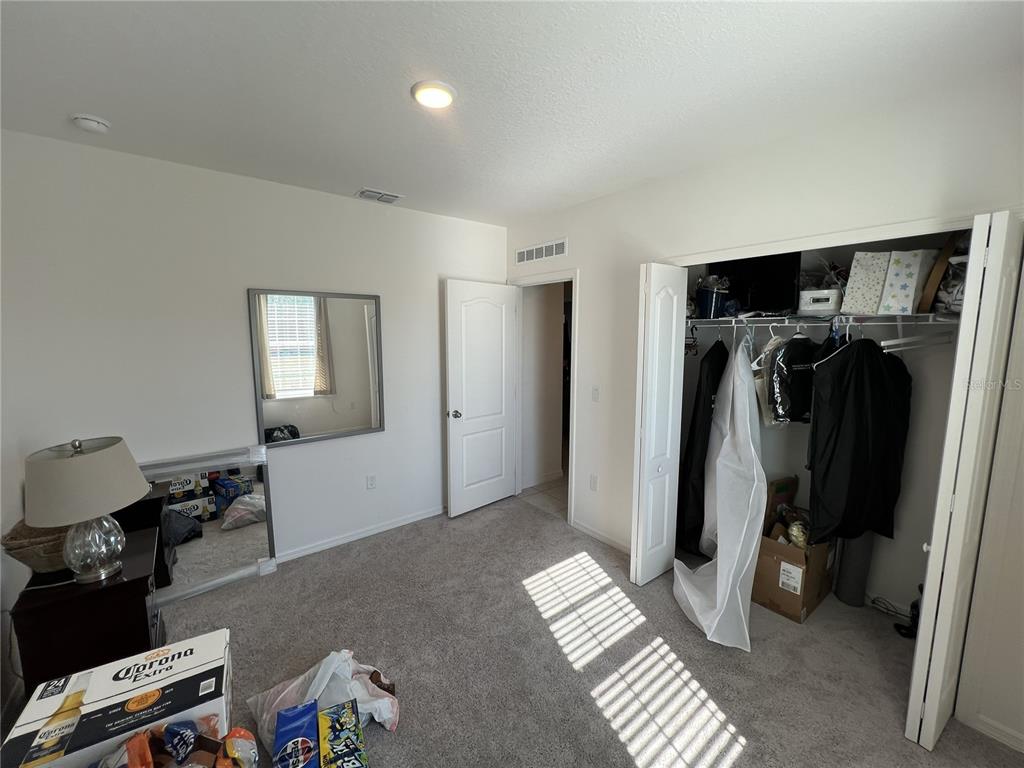 1106 Althea Drive Indian Lake Estates, FL 33843 - Photo 19 of 56 a view of walk in closet with clothes and shoes