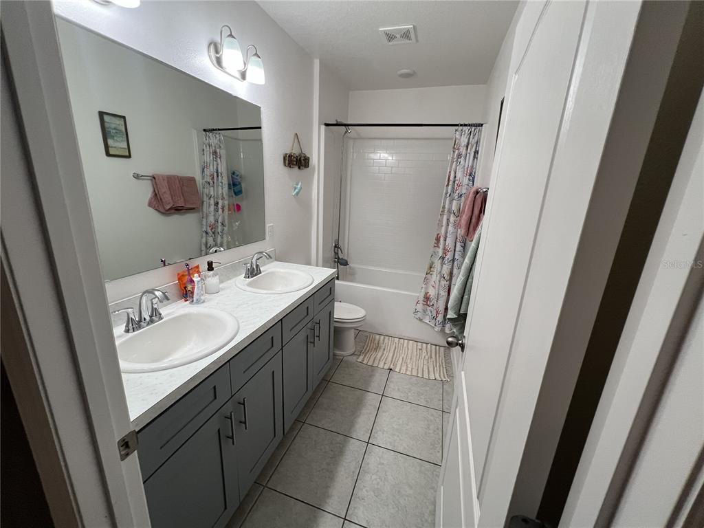1106 Althea Drive Indian Lake Estates, FL 33843 - Photo 20 of 56 a bathroom with a sink a toilet and shower a mirror