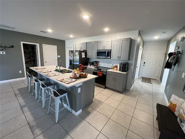 a kitchen with a sink a counter top space and stainless steel appliances