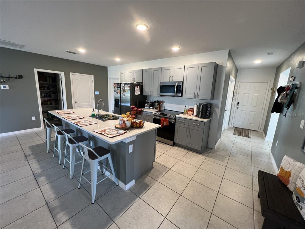1106 Althea Drive Indian Lake Estates, FL 33843 - Photo 2 of 56 a kitchen with a sink a counter top space and stainless steel appliances