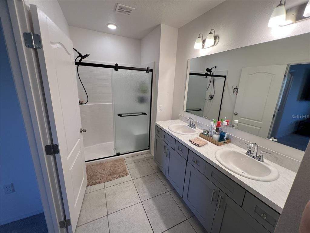 1106 Althea Drive Indian Lake Estates, FL 33843 - Photo 6 of 56 a bathroom with double vanity sink and mirror