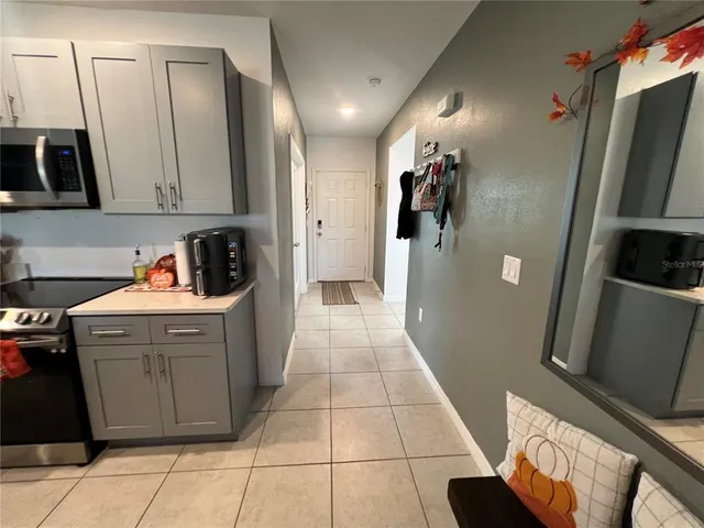 a kitchen with a sink a refrigerator and cabinets
