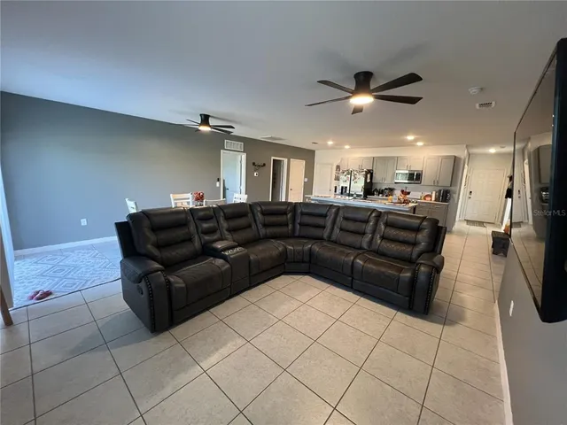 a dining area with furniture and a flat screen tv