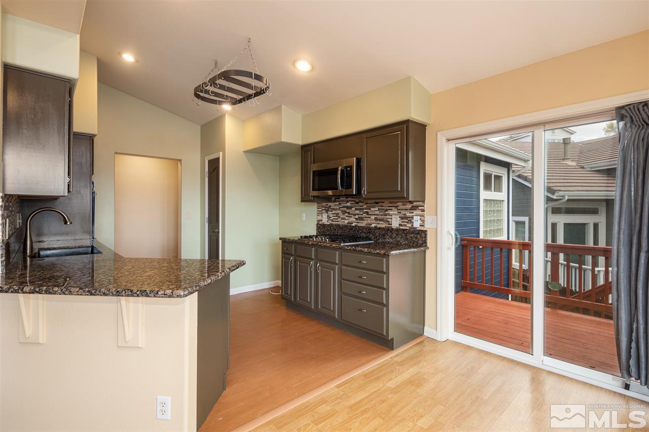 2259 Ridgeview Drive Reno, NV 89519 - Photo 11 of 39 a large kitchen with kitchen island granite countertop a stove and a sink