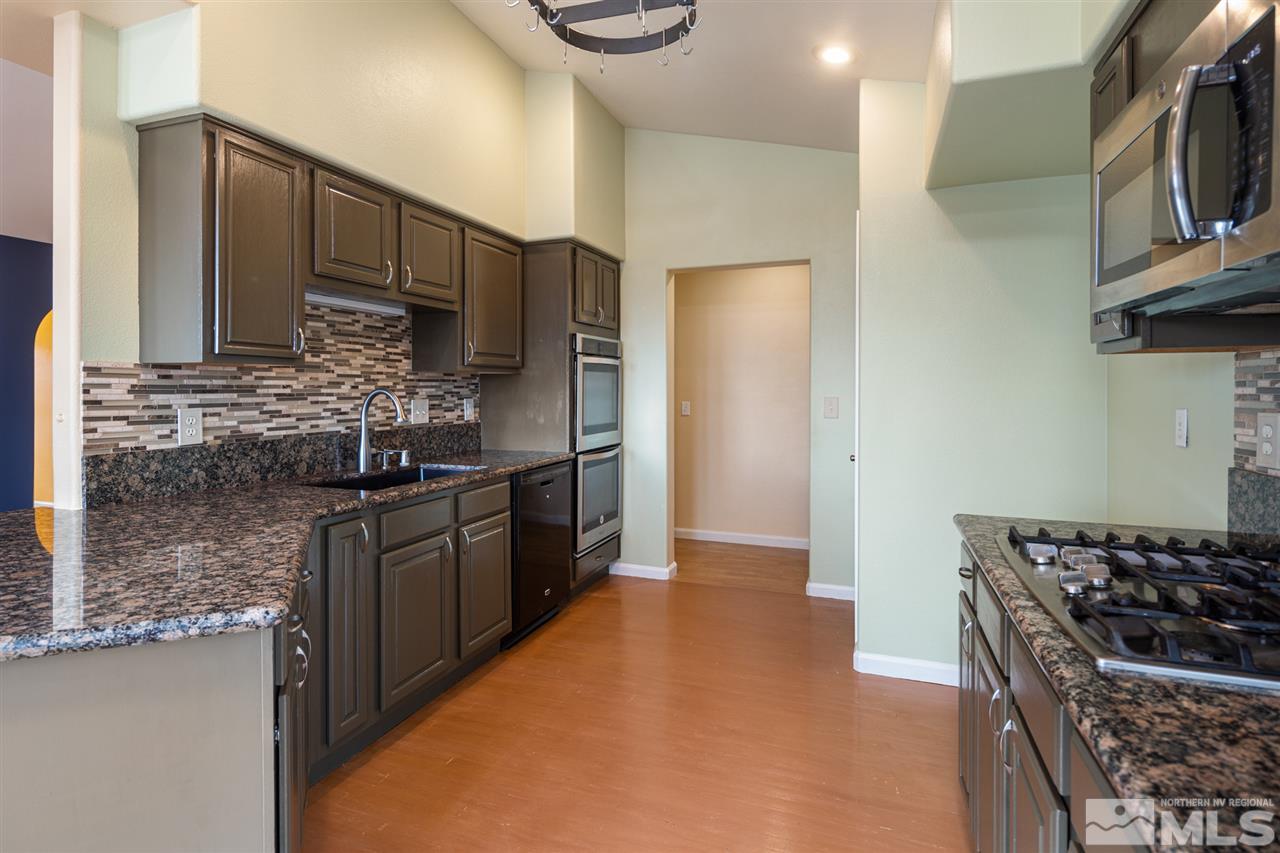 2259 Ridgeview Drive Reno, NV 89519 - Photo 12 of 39 a kitchen with stainless steel appliances granite countertop a stove a sink and a refrigerator