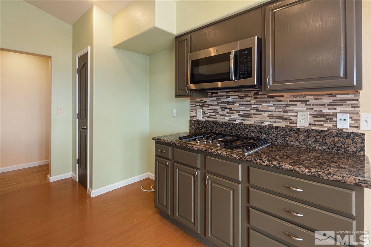 2259 Ridgeview Drive Reno, NV 89519 - Photo 13 of 39 a kitchen with granite countertop a stove and a microwave