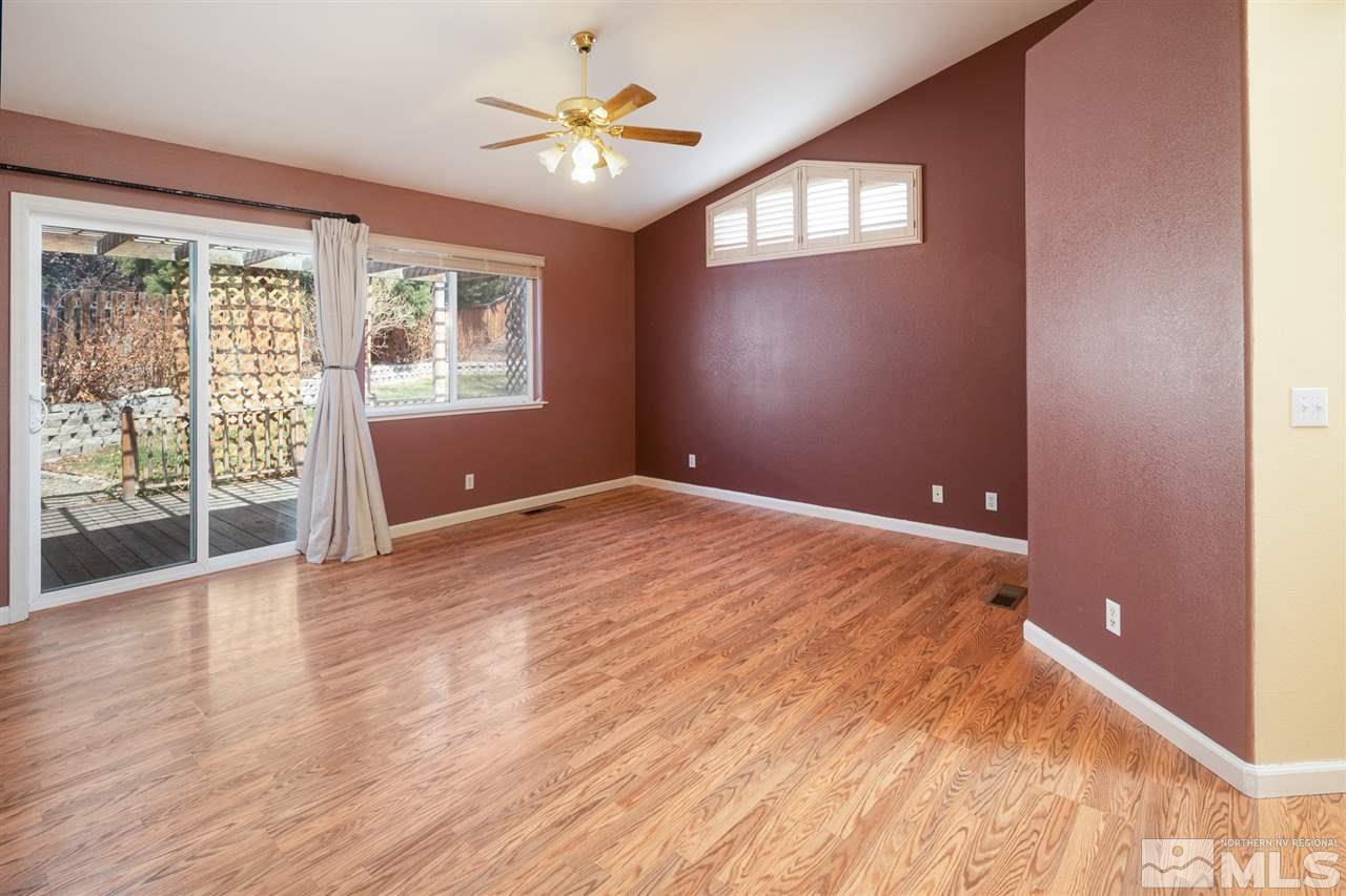 2259 Ridgeview Drive Reno, NV 89519 - Photo 17 of 39 a view of an empty room with a window and wooden floor