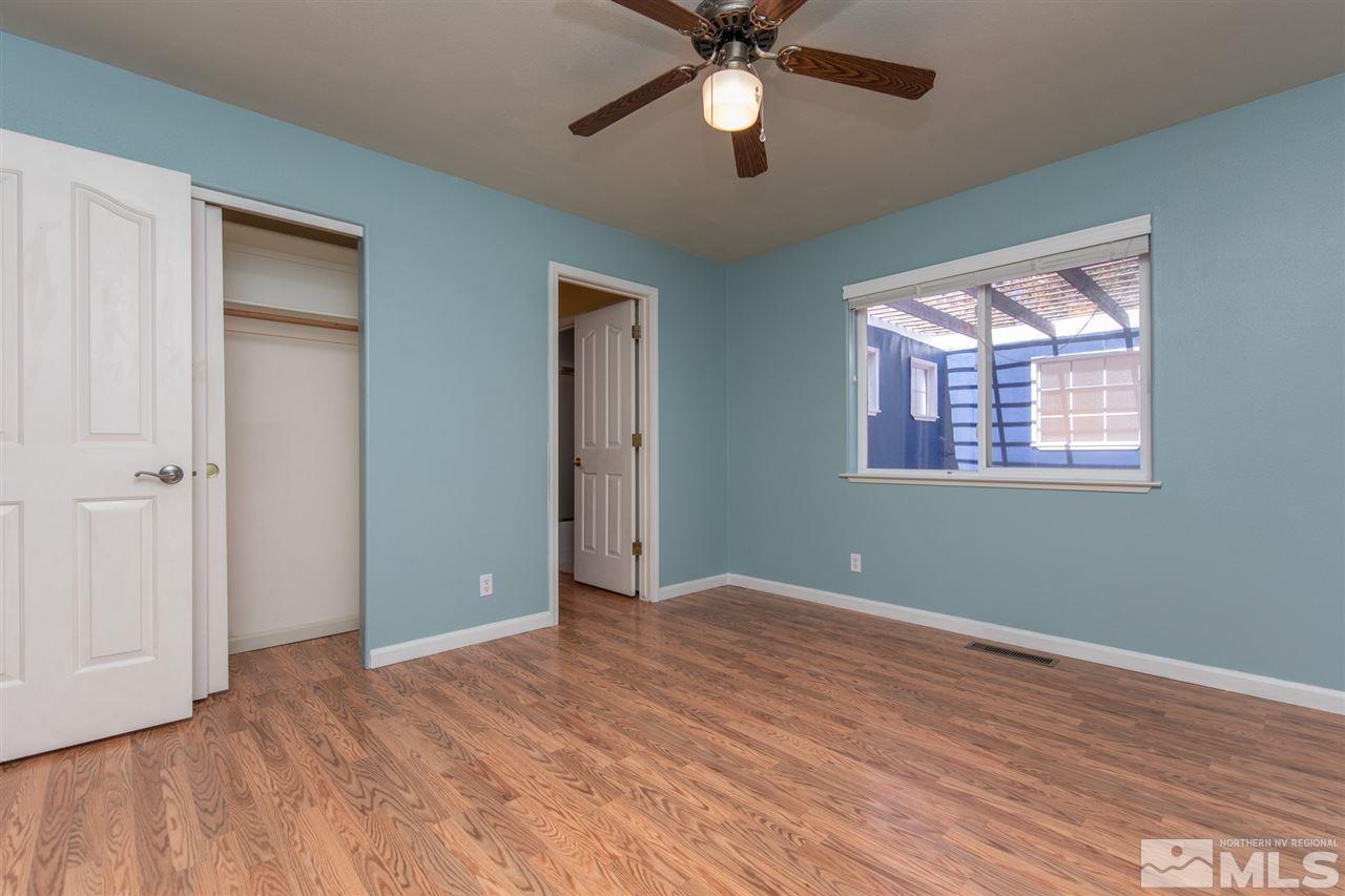 2259 Ridgeview Drive Reno, NV 89519 - Photo 23 of 39 a view of an empty room with a window and wooden floor