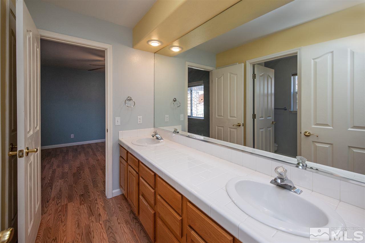 2259 Ridgeview Drive Reno, NV 89519 - Photo 24 of 39 a en suite bathroom with a double vanity sink and a mirror