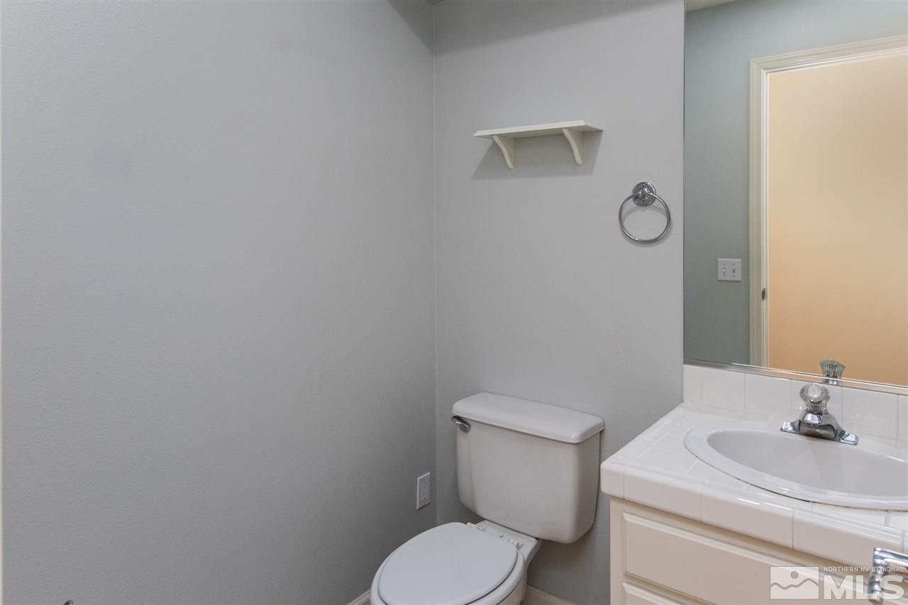 2259 Ridgeview Drive Reno, NV 89519 - Photo 26 of 39 a white toilet sitting next to a bathroom sink