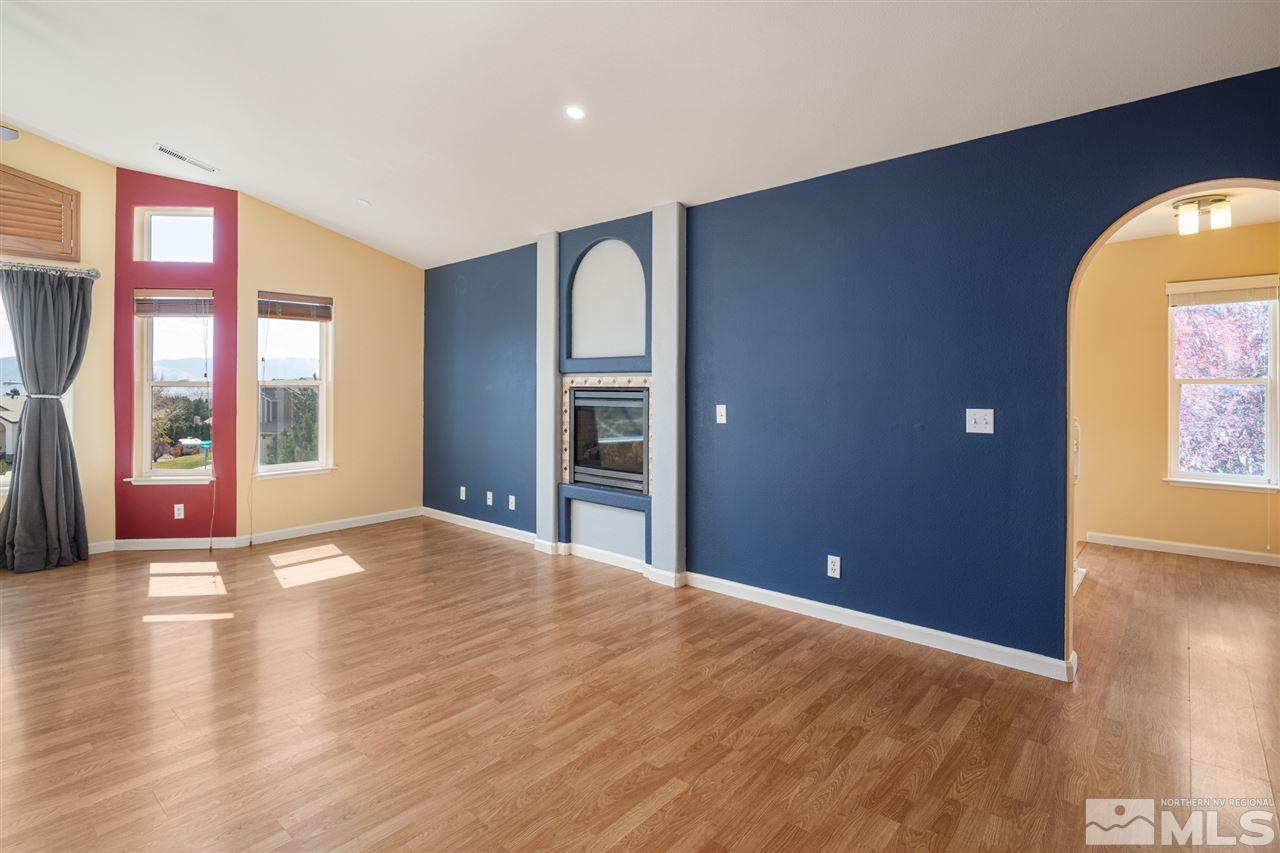 2259 Ridgeview Drive Reno, NV 89519 - Photo 7 of 39 a view of an empty room with a window and wooden floor