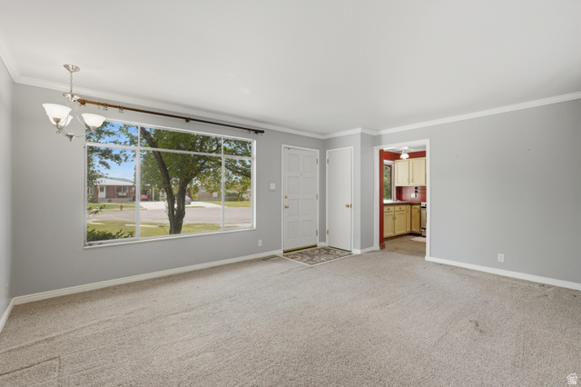 378 West 200 South Bountiful, UT 84010 - Photo 7 of 32 Living area featuring a large picture window, a flush-mount chandelier, light-toned carpeting, and a white entry door