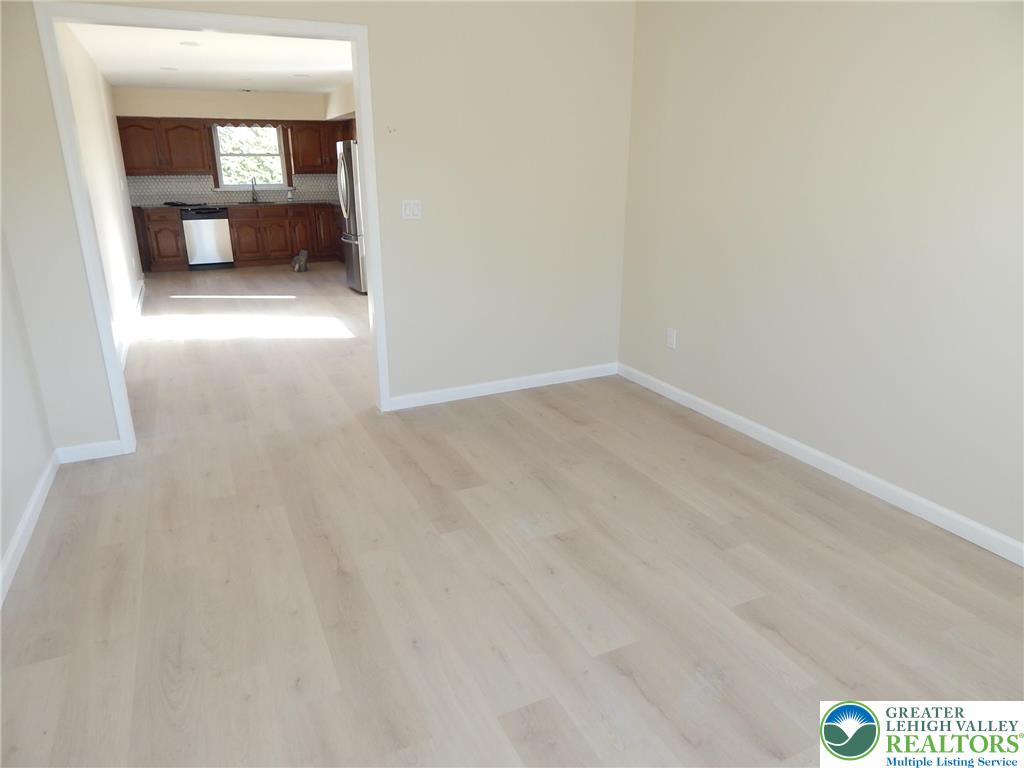 4117 Grape Street Coplay, PA 18037 - Photo 3 of 41 a view of a hallway with wooden floor and a bathroom