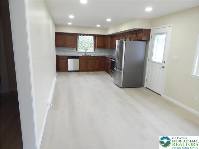 a view of kitchen with refrigerator and microwave