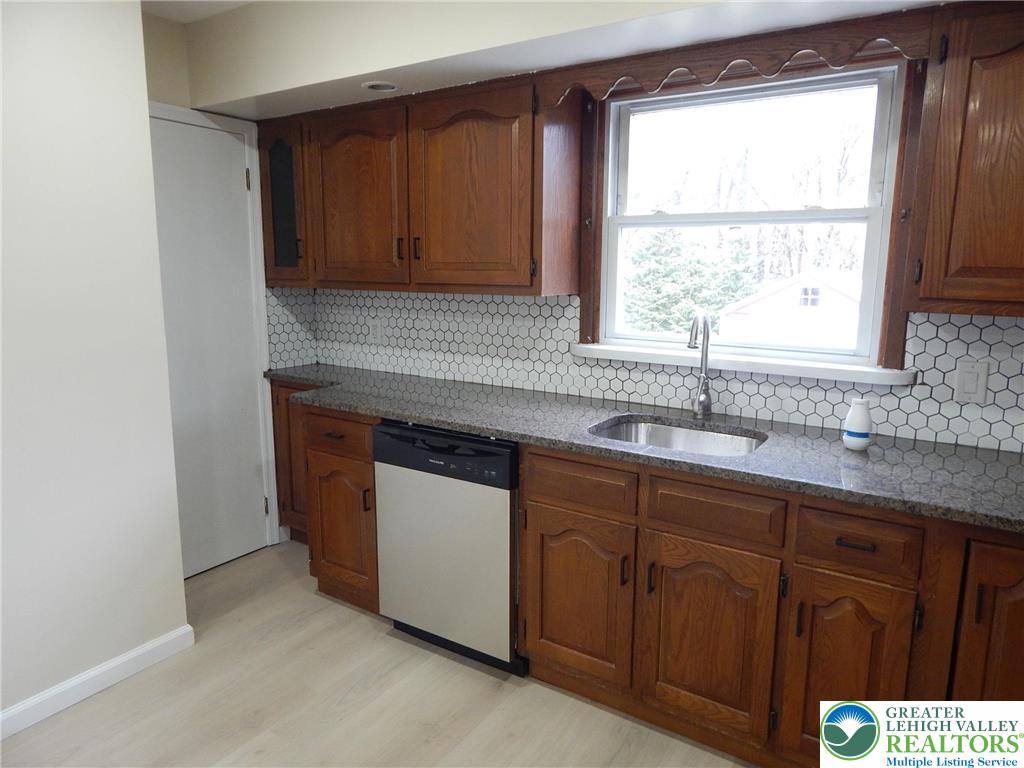 4117 Grape Street Coplay, PA 18037 - Photo 7 of 41 a kitchen with stainless steel appliances granite countertop a sink and a window