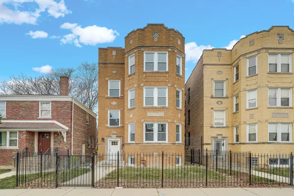 a front view of a residential apartment building with a yard
