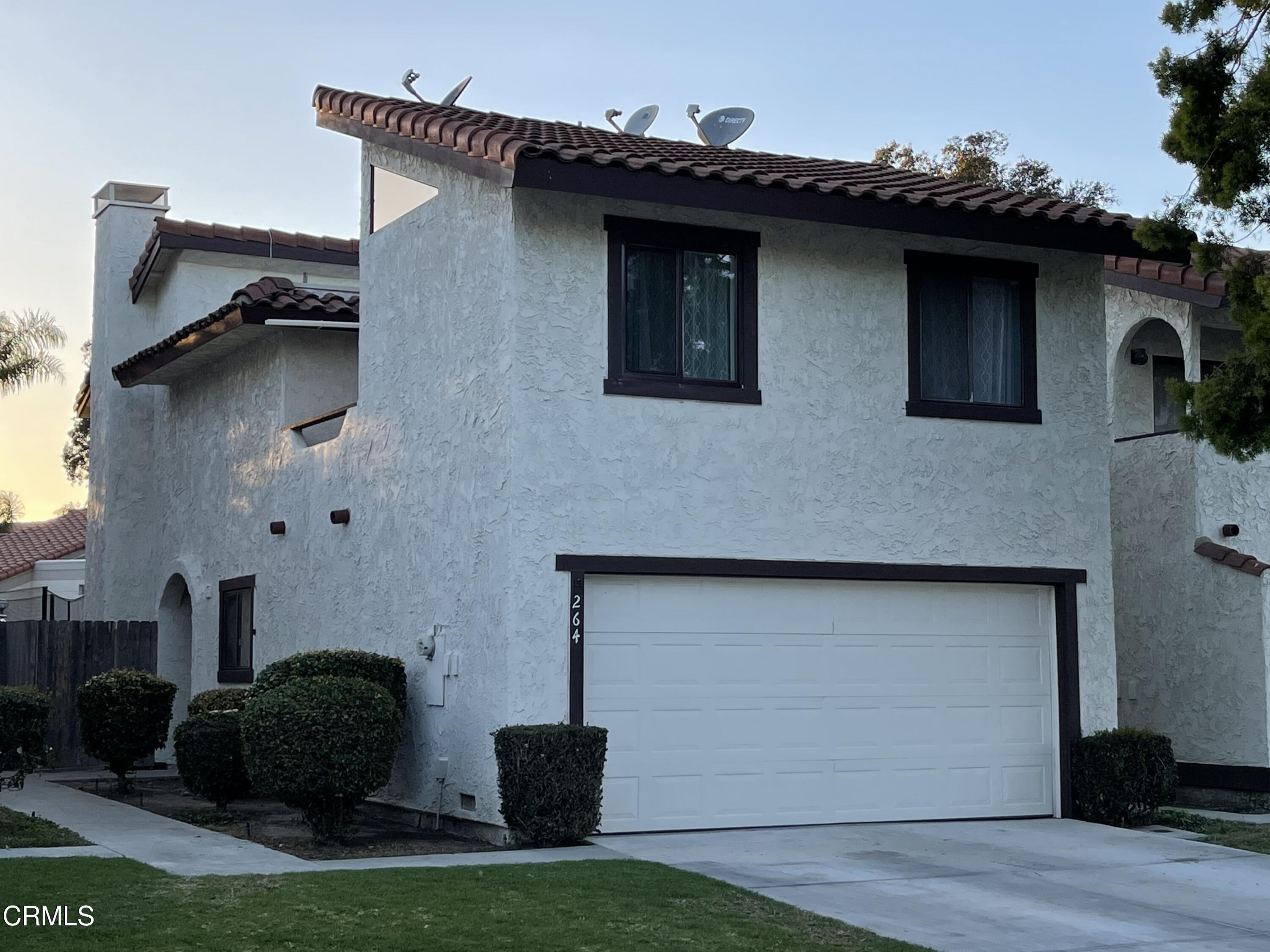 264 East Bard Road Oxnard, CA 93033 - Photo 1 of 17 a front view of a house with garage