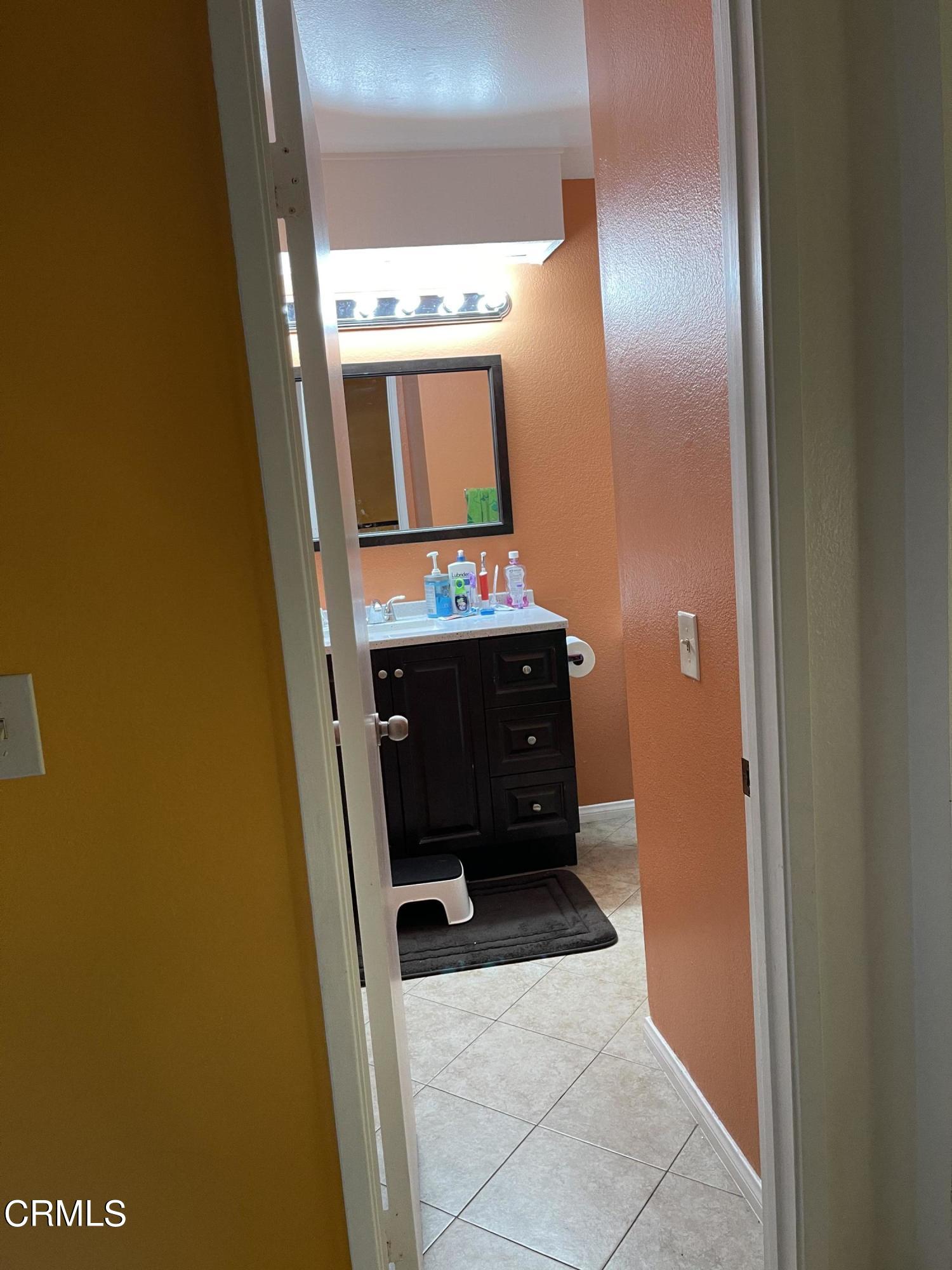 264 East Bard Road Oxnard, CA 93033 - Photo 14 of 17 a bathroom with a sink and a mirror