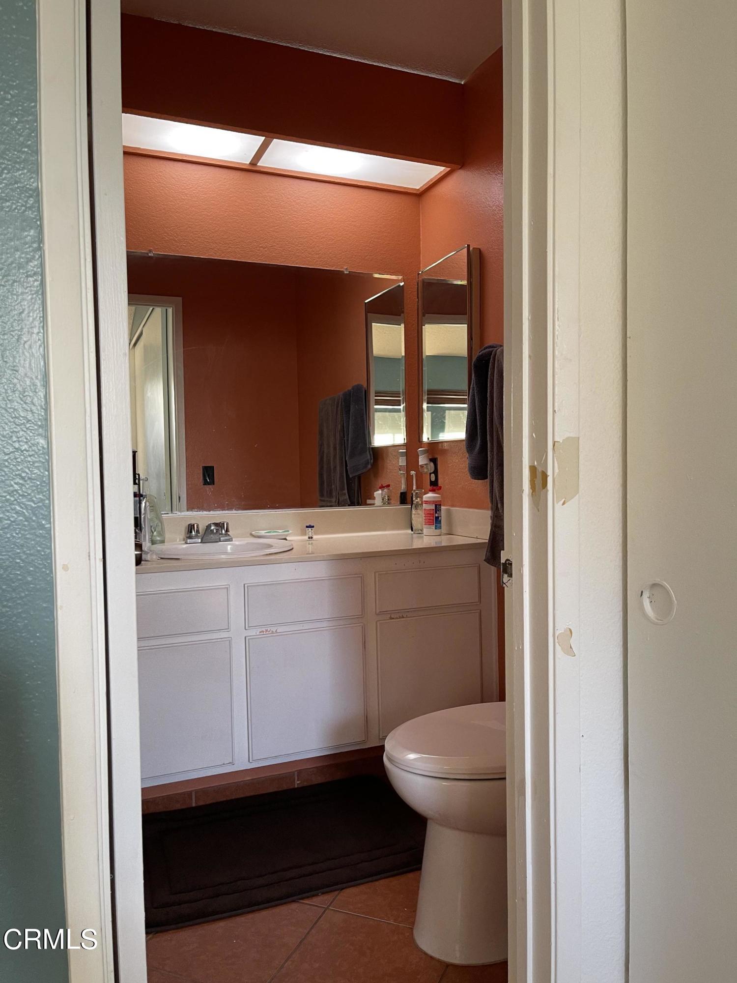 264 East Bard Road Oxnard, CA 93033 - Photo 17 of 17 a bathroom with a sink a toilet and a mirror