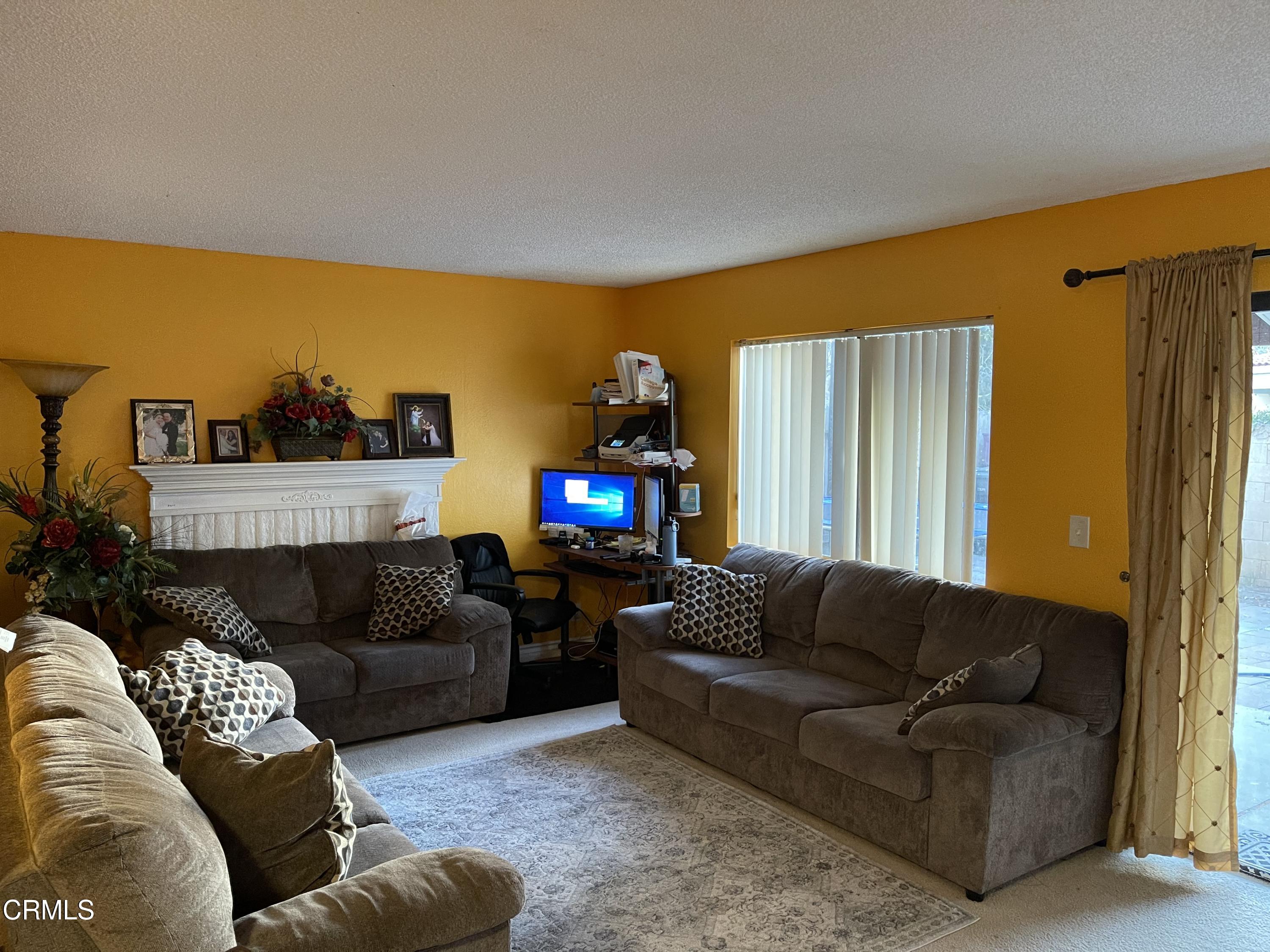 264 East Bard Road Oxnard, CA 93033 - Photo 4 of 17 a living room with furniture and a flat screen tv