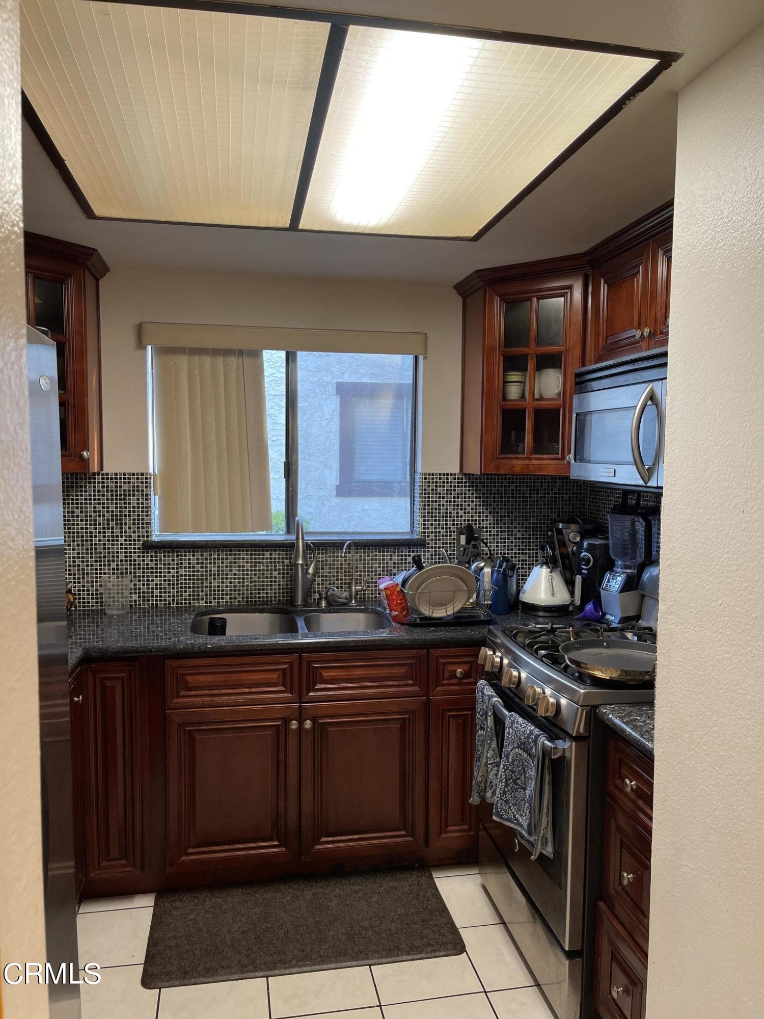 264 East Bard Road Oxnard, CA 93033 - Photo 5 of 17 a kitchen with a sink and cabinets
