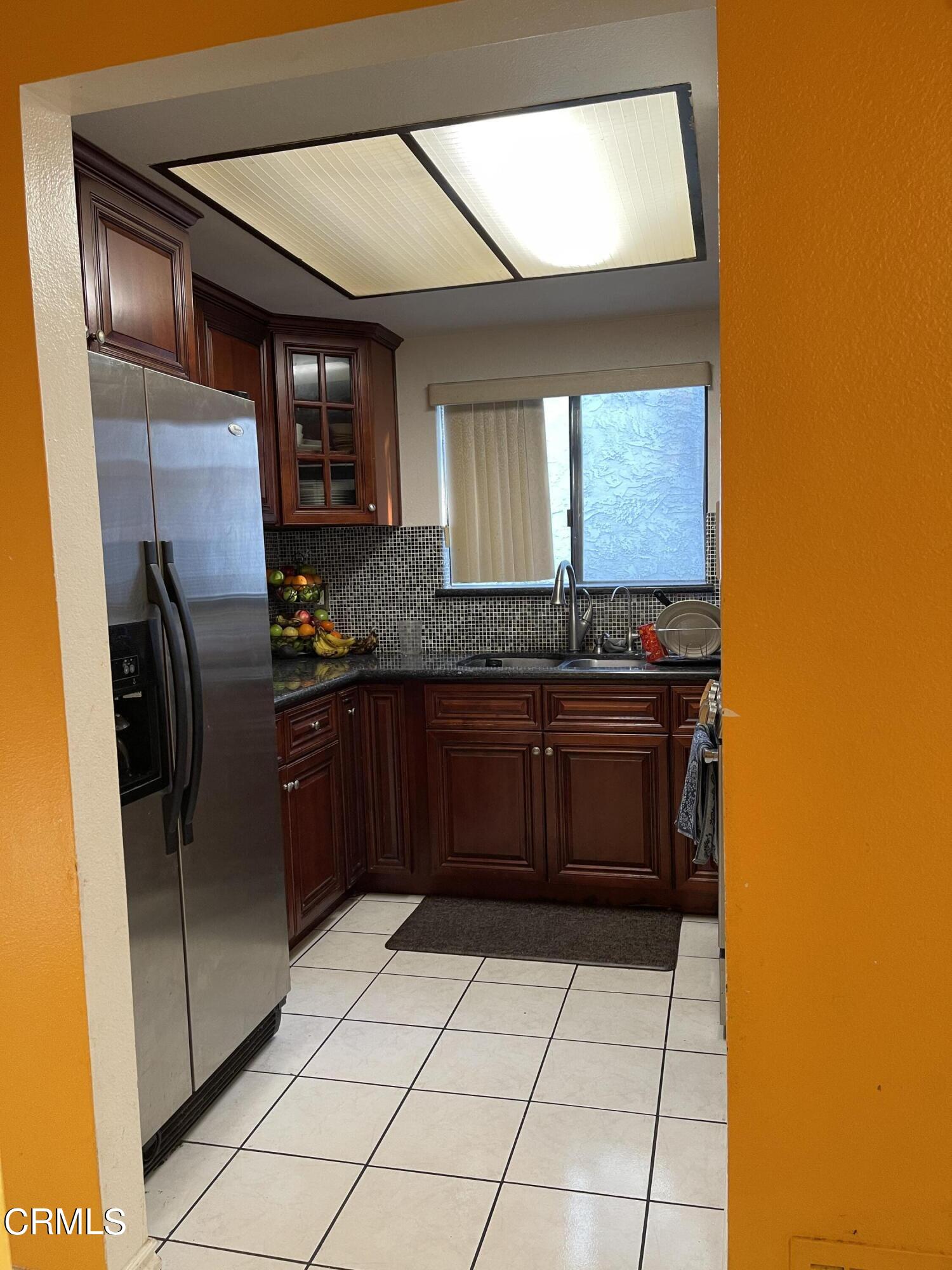 264 East Bard Road Oxnard, CA 93033 - Photo 6 of 17 a kitchen with granite countertop a refrigerator and a sink