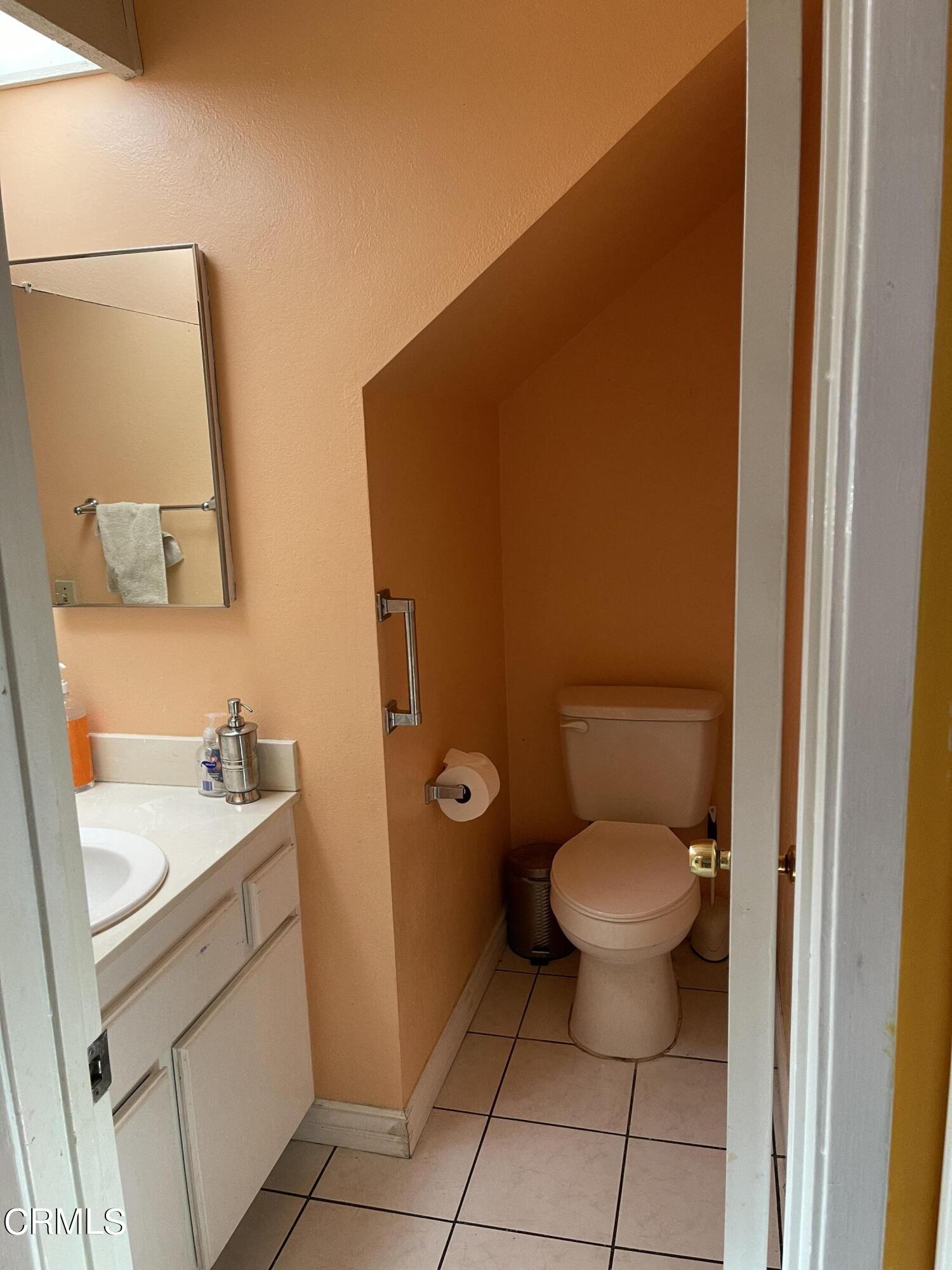 264 East Bard Road Oxnard, CA 93033 - Photo 7 of 17 a bathroom with a granite countertop toilet and a sink