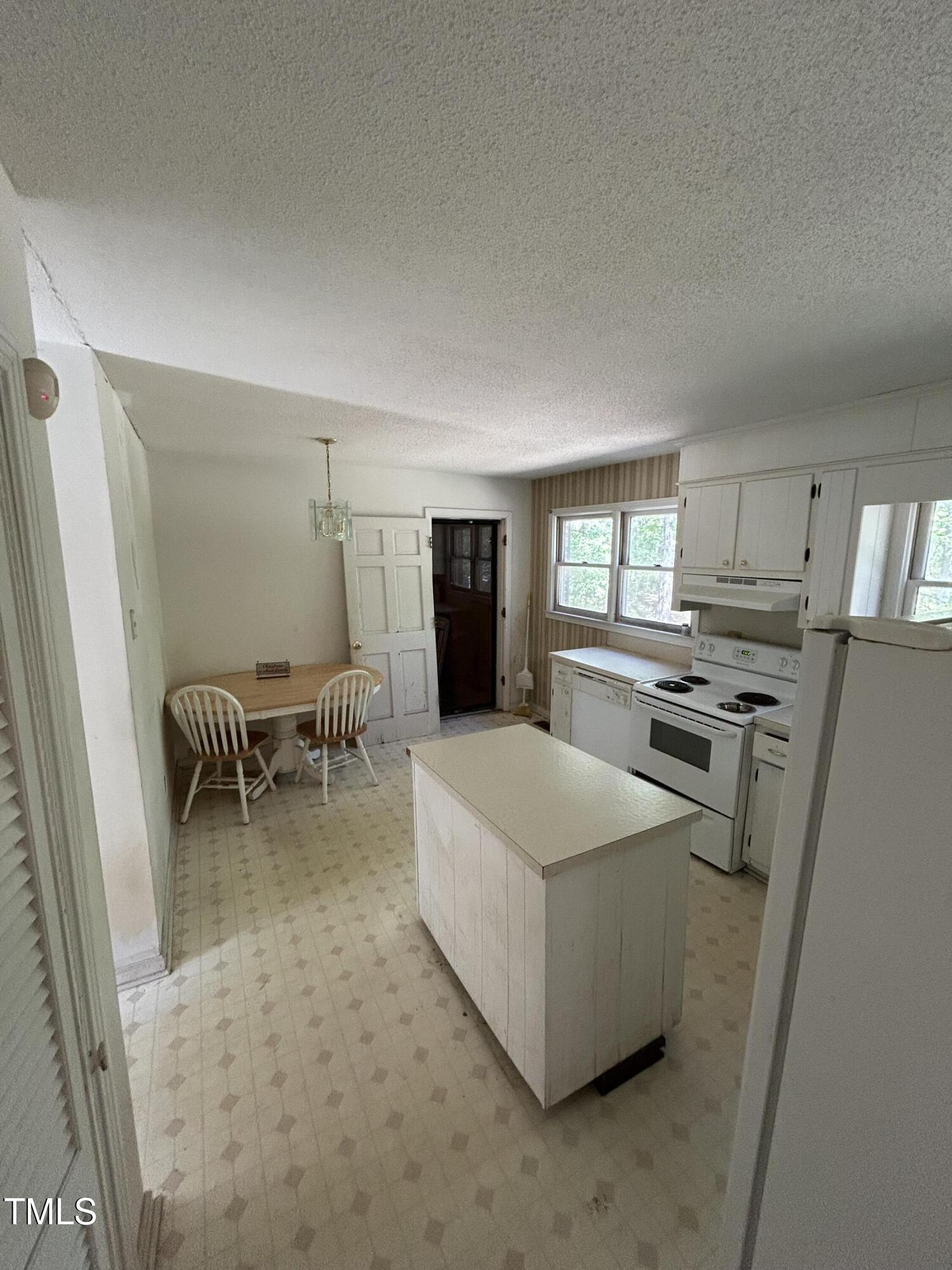 683 Osgood Road Sanford, NC 27330 - Photo 5 of 13 a living room with furniture a flat screen tv and a table