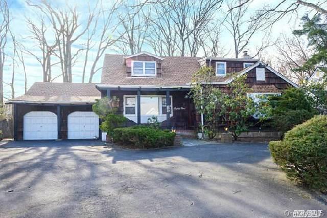 89 Hungry Harbor Road Valley Stream, NY 11581 - Photo 1 of 1 a front view of a house with a garden and trees