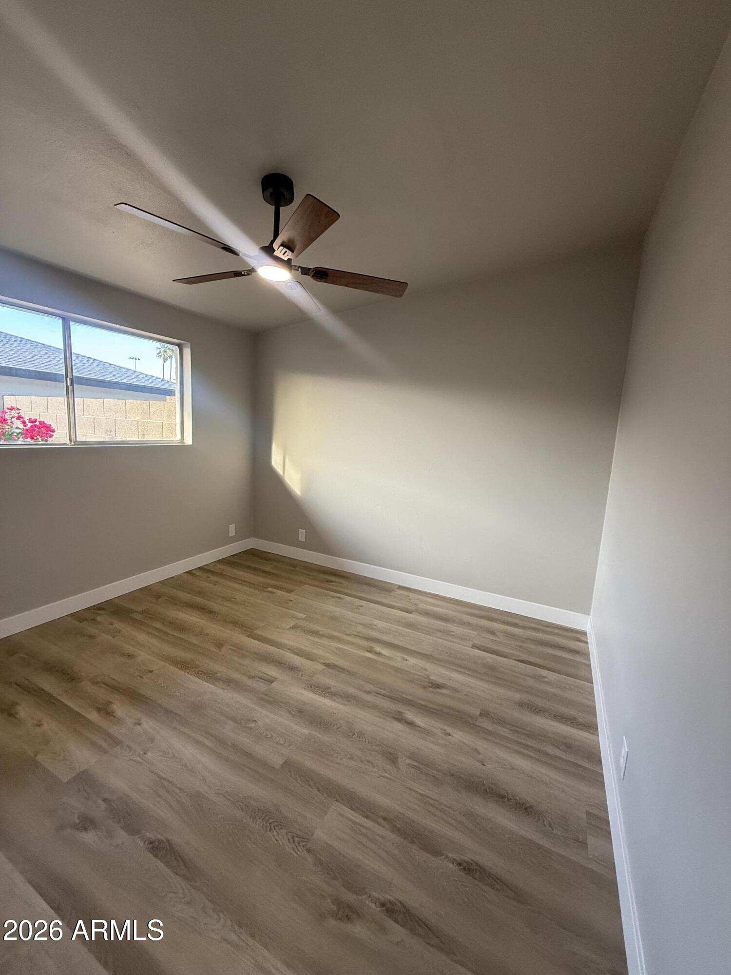 5420 North Granite Reef Road Scottsdale, AZ 85250 - Photo 16 of 30 an empty room with wooden floor and windows