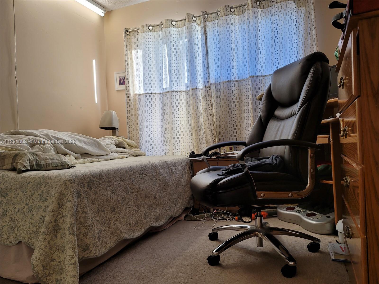 3931 Southwest 84th Terrace Davie, FL 33328 - Photo 13 of 15 a bedroom with a bed and a chair