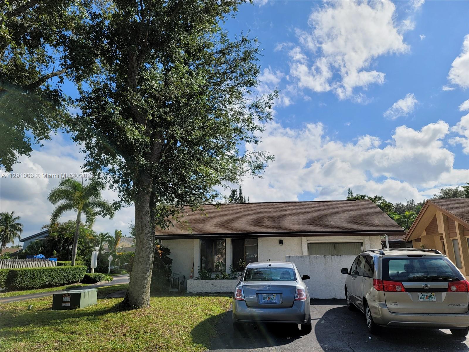3931 Southwest 84th Terrace Davie, FL 33328 - Photo 2 of 15 a car parked in front of a house and cars parked