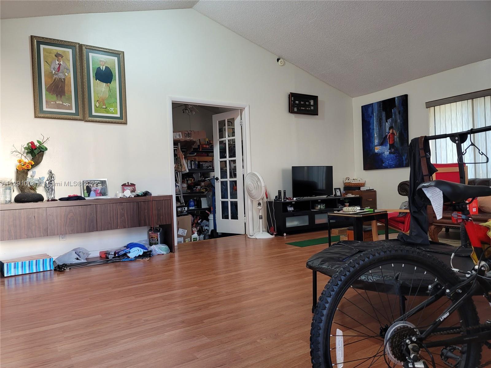 3931 Southwest 84th Terrace Davie, FL 33328 - Photo 8 of 15 a living room with furniture and a flat screen tv