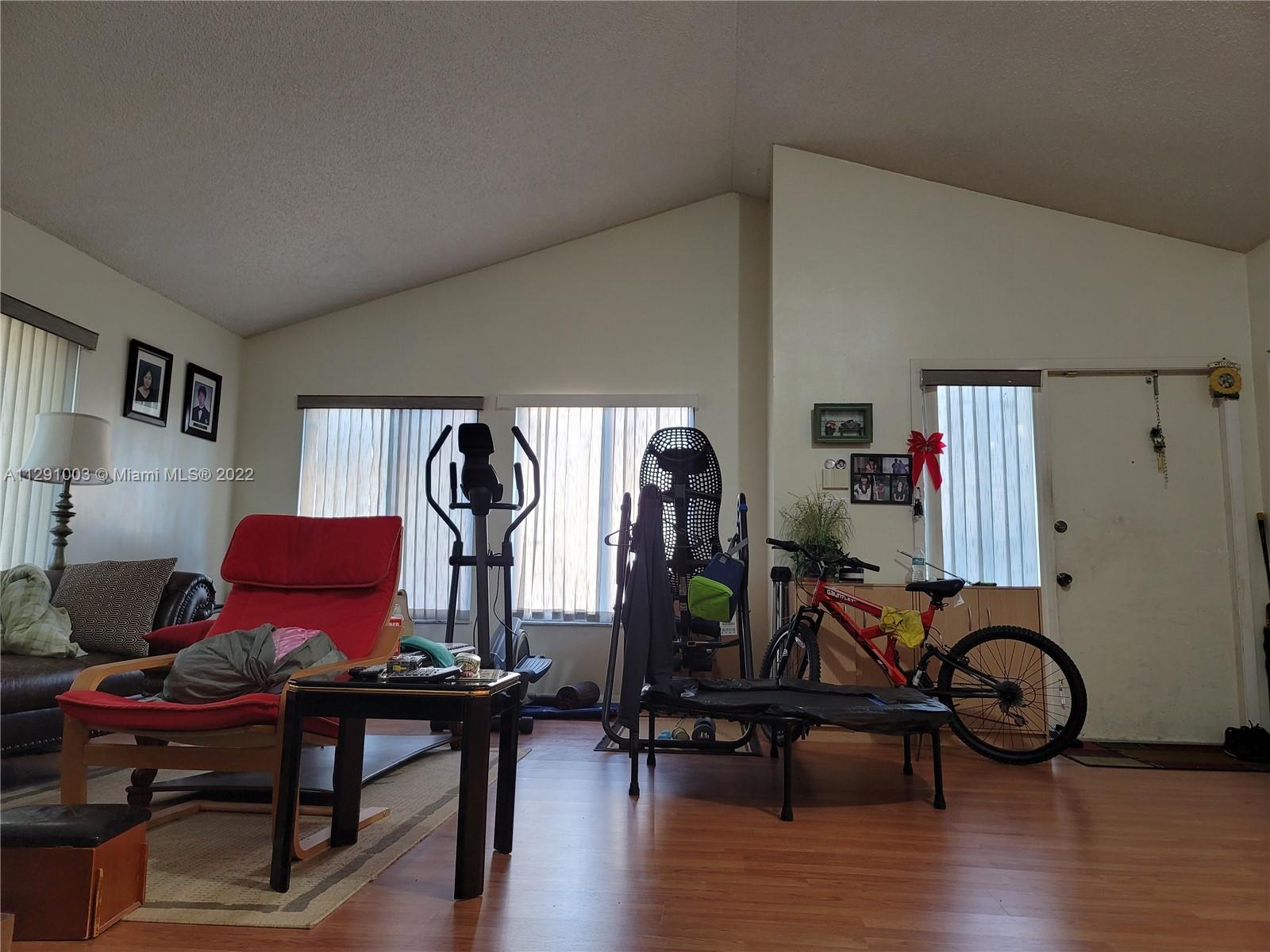 3931 Southwest 84th Terrace Davie, FL 33328 - Photo 9 of 15 a view of a livingroom with furniture and gym equipment