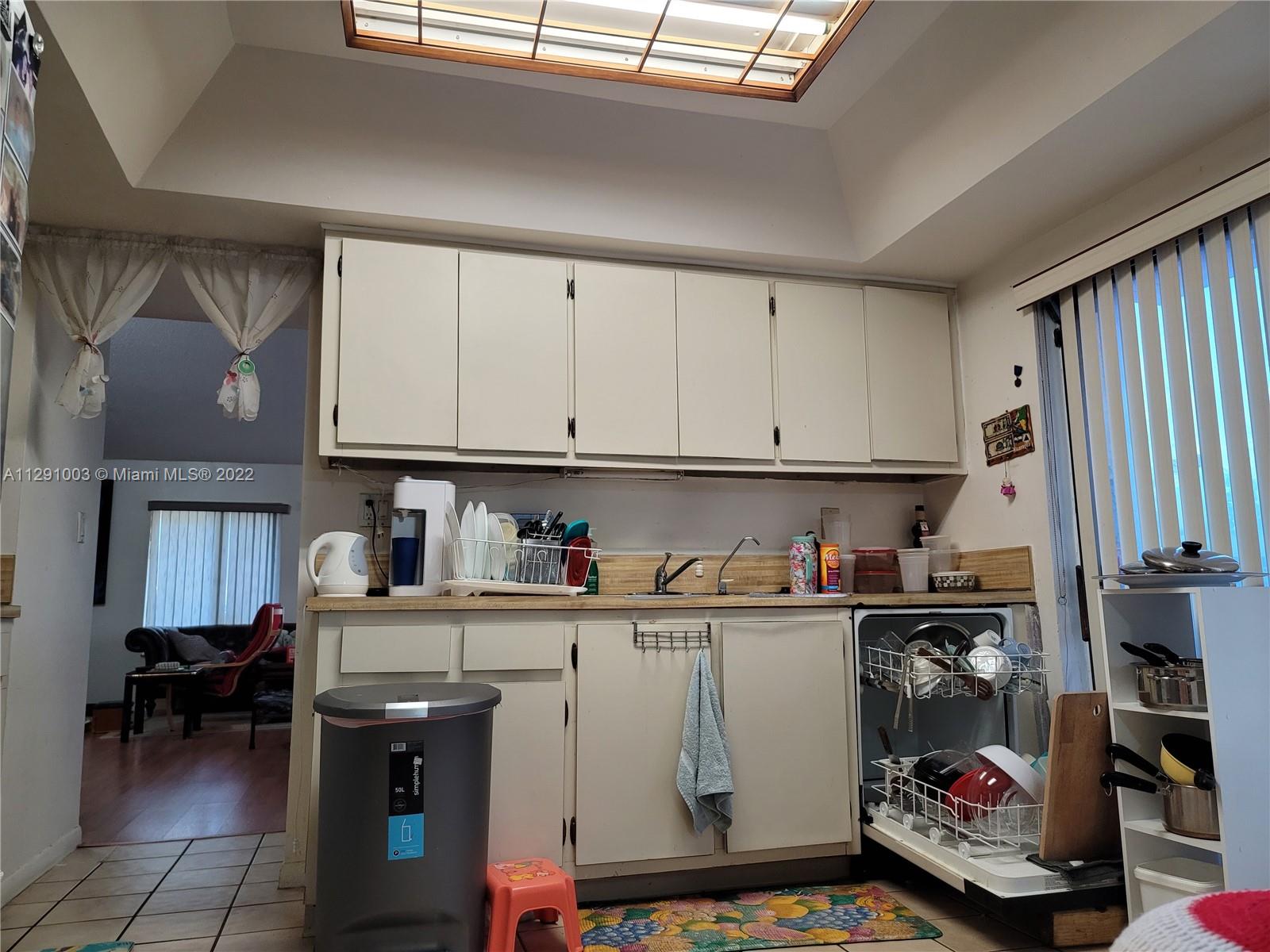 3931 Southwest 84th Terrace Davie, FL 33328 - Photo 10 of 15 a room with a white cabinets a sink and a stove